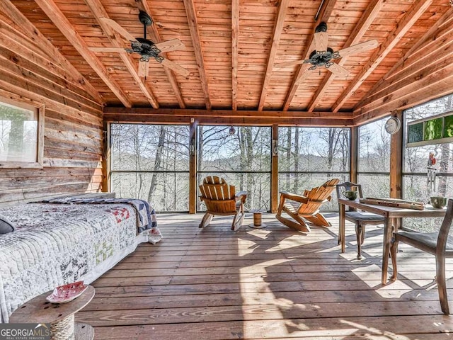 sunroom / solarium with vaulted ceiling with beams, ceiling fan, and wood ceiling