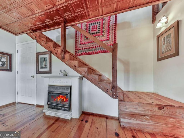 stairs featuring hardwood / wood-style floors