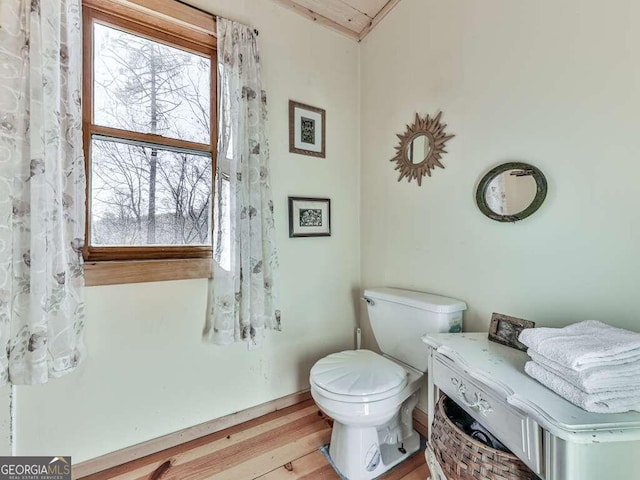 bathroom featuring hardwood / wood-style flooring and toilet