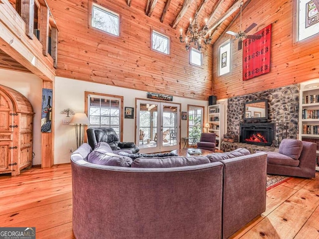 living room featuring plenty of natural light, beamed ceiling, light hardwood / wood-style flooring, and high vaulted ceiling