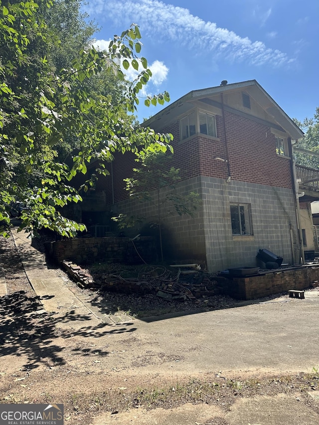 view of side of home featuring brick siding