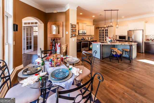 dining space featuring dark hardwood / wood-style flooring and crown molding