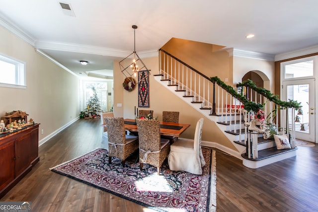 dining area featuring crown molding, a chandelier, and dark hardwood / wood-style floors