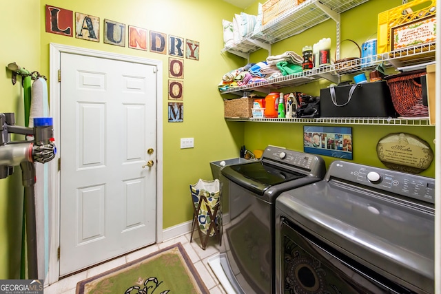 laundry area featuring washer and dryer and light tile patterned flooring