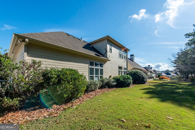 view of side of property featuring a yard