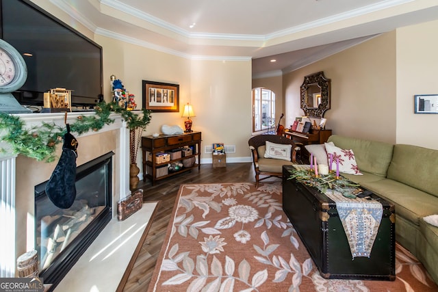 living room with dark hardwood / wood-style flooring and crown molding