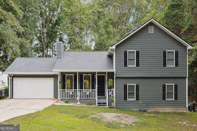 split level home with covered porch, a front yard, and a garage