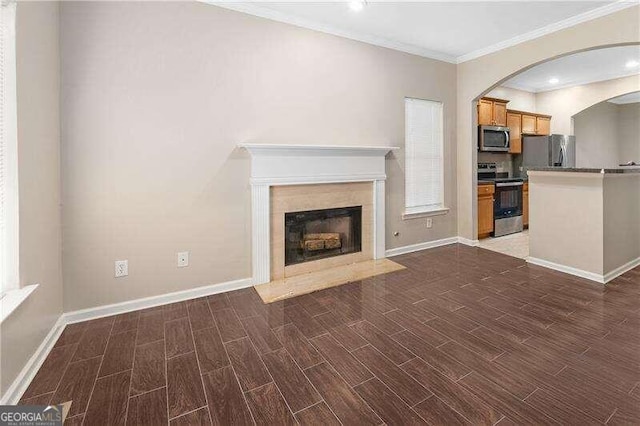 unfurnished living room with dark hardwood / wood-style flooring and ornamental molding