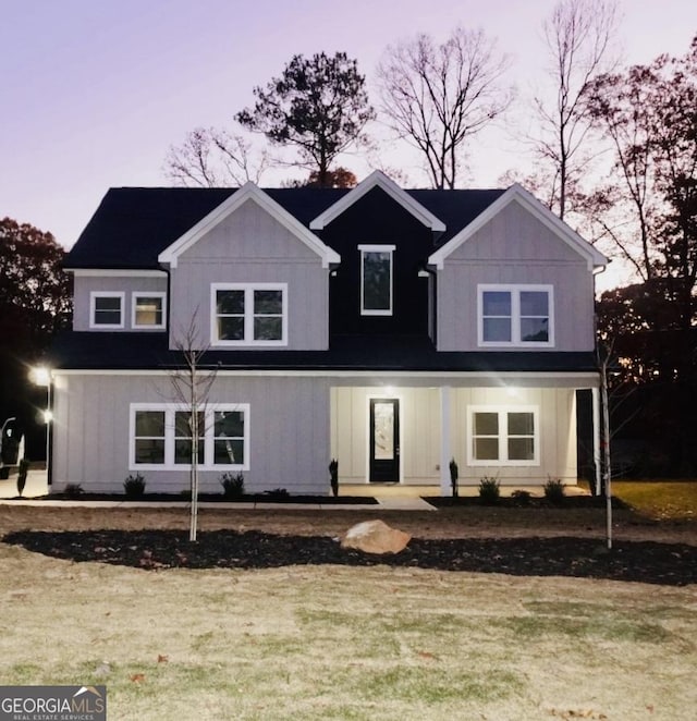 view of front facade featuring board and batten siding and a front yard