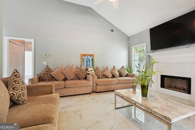 living room with ceiling fan, a fireplace, and high vaulted ceiling