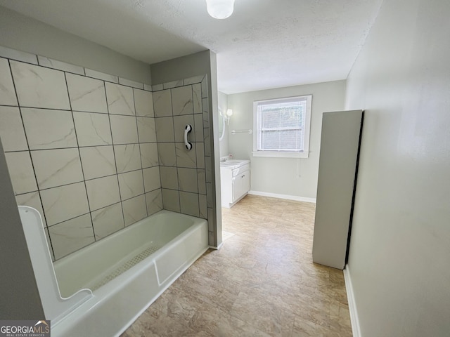 bathroom with vanity and tiled shower / bath combo