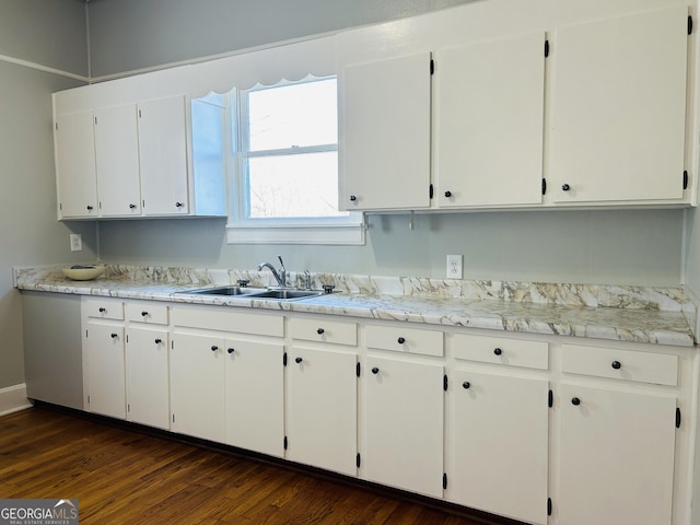 kitchen with dark hardwood / wood-style flooring, white cabinetry, and sink