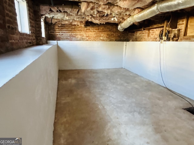 basement with brick wall