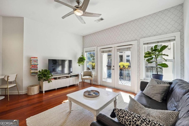 living area with ceiling fan, baseboards, french doors, dark wood-style floors, and wallpapered walls