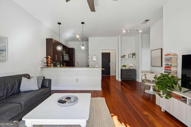 living room with ceiling fan and dark hardwood / wood-style floors