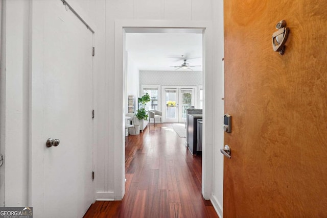 hall featuring dark wood-type flooring and french doors