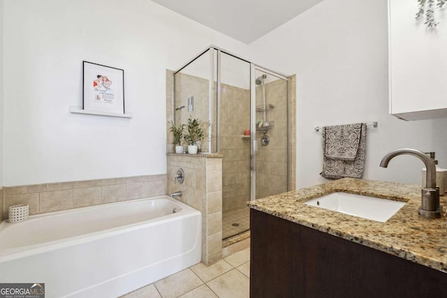 bathroom featuring a garden tub, a stall shower, tile patterned flooring, and vanity