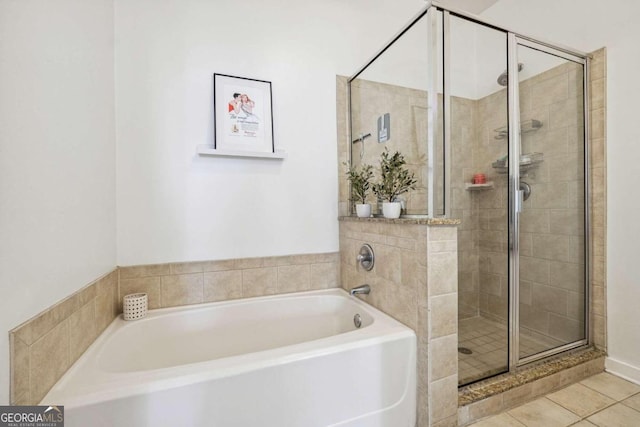 bathroom with tile patterned floors and independent shower and bath