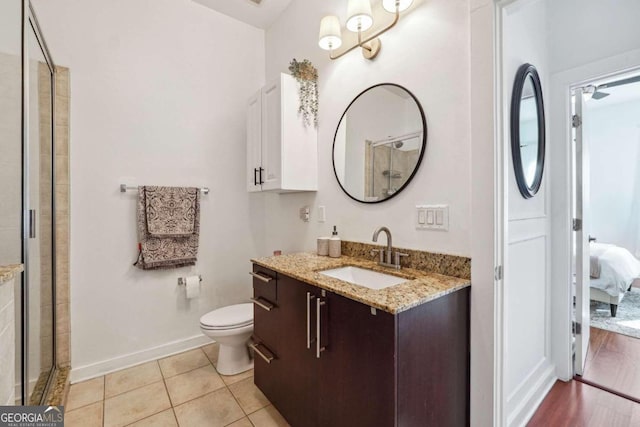 bathroom with walk in shower, vanity, wood-type flooring, and toilet