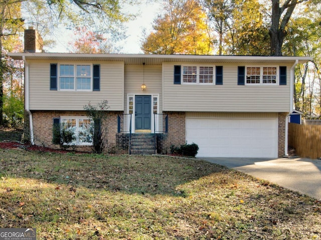 1304 Vine St NE, Gainesville, GA 30501 - raised ranch with a chimney, brick siding, and an attached garage