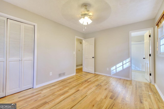 1304 Vine St NE, Gainesville, GA 30501 - unfurnished bedroom featuring wood finished floors, ensuite bathroom, ceiling fan, and a closet