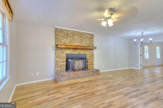 1304 Vine St NE, Gainesville, GA 30501 - unfurnished living room featuring a textured ceiling, wood finished floors, a chandelier, and a ceiling fan