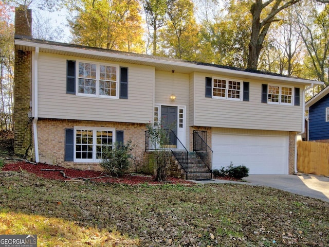 1304 Vine St NE, Gainesville, GA 30501 - raised ranch featuring brick siding, driveway, and an attached garage
