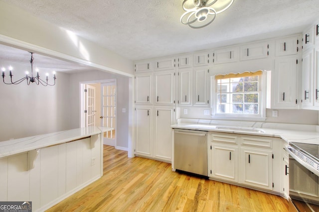 kitchen with stainless steel appliances, pendant lighting, a textured ceiling, light hardwood / wood-style floors, and white cabinets