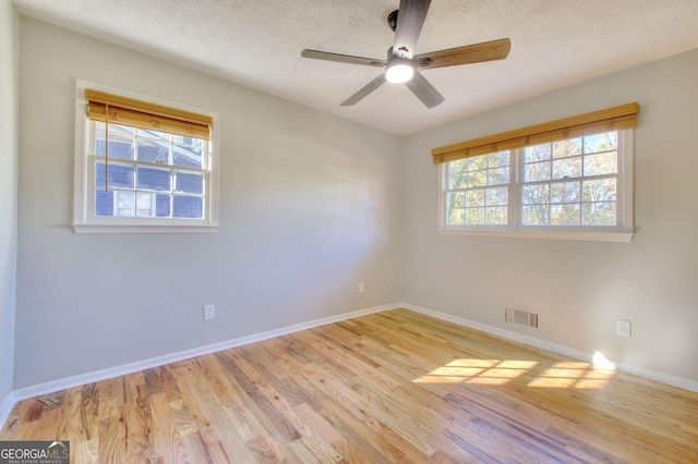 1304 Vine St NE, Gainesville, GA 30501 - spare room featuring light wood-type flooring, a ceiling fan, and a textured ceiling