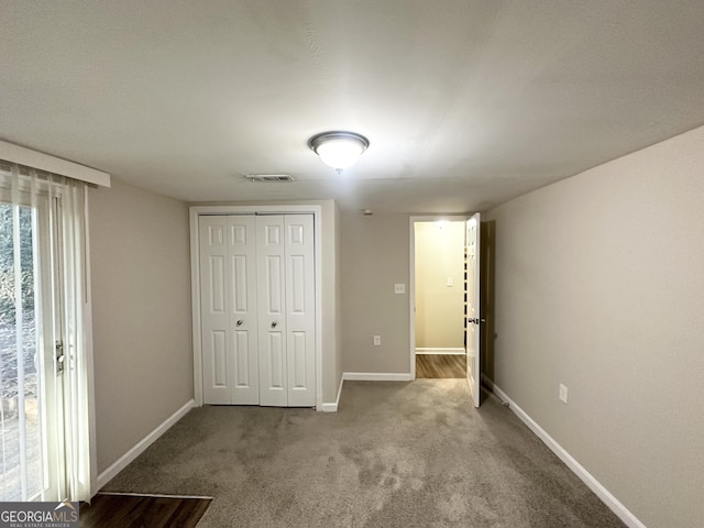 unfurnished bedroom with carpet flooring and a closet