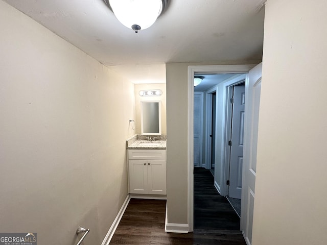 hall featuring dark hardwood / wood-style floors and sink