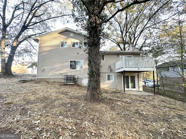 rear view of house with a wooden deck