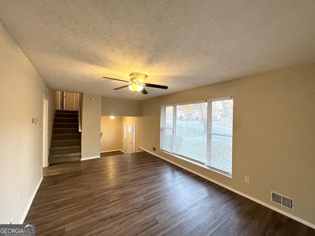 unfurnished living room featuring a textured ceiling, dark hardwood / wood-style flooring, and ceiling fan