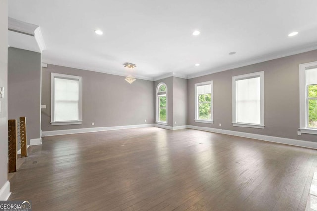 interior space with a notable chandelier, dark hardwood / wood-style floors, and ornamental molding