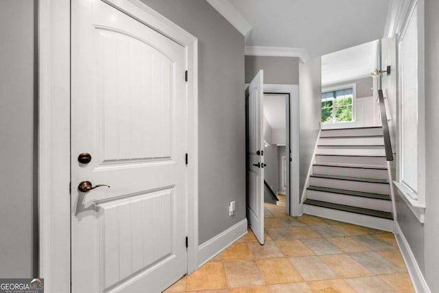 stairs featuring crown molding