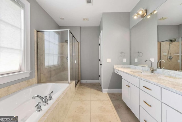 bathroom with tile patterned floors, vanity, and shower with separate bathtub