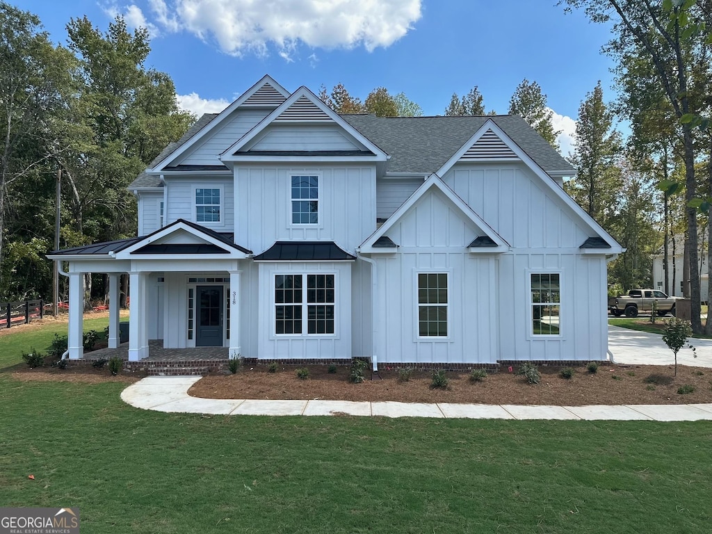 view of front of home with covered porch and a front yard