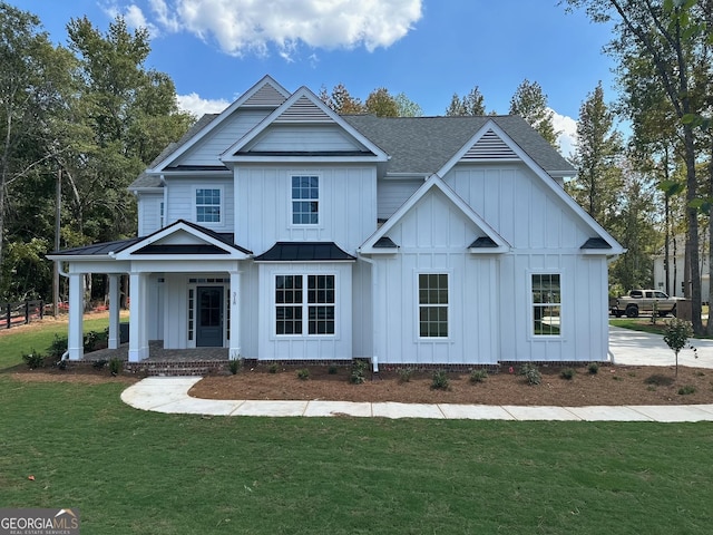 view of front of home with covered porch and a front yard