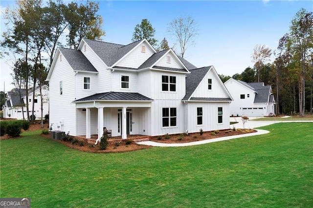 modern farmhouse style home with covered porch and a front lawn