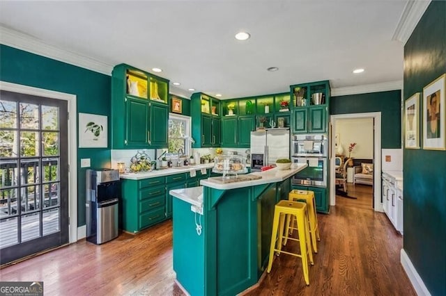 kitchen with dark wood-type flooring, stainless steel appliances, plenty of natural light, and a kitchen island