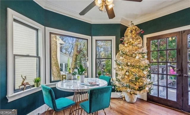 sunroom / solarium featuring ceiling fan and french doors