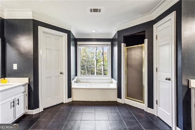 bathroom featuring plus walk in shower, vanity, and tile patterned flooring