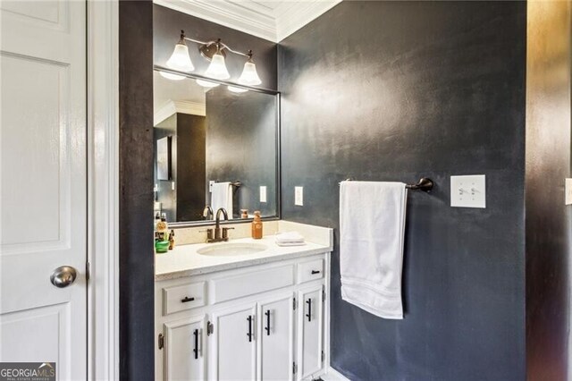 bathroom with tile patterned flooring, ornamental molding, and vanity