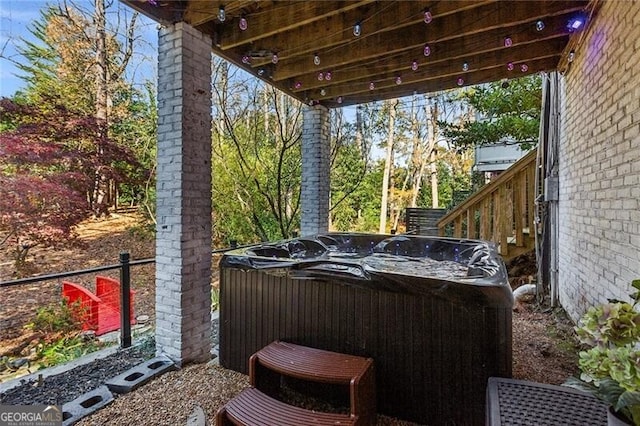 view of patio with a hot tub