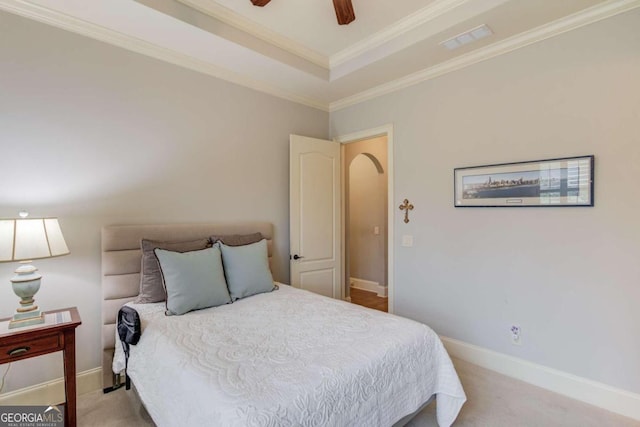 bedroom with ceiling fan, crown molding, and light carpet