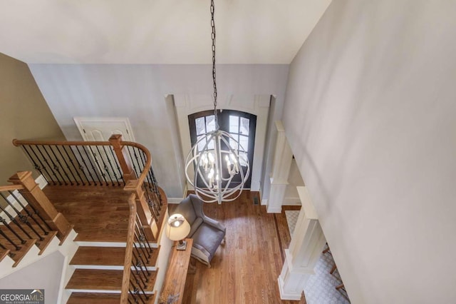 foyer featuring hardwood / wood-style floors and an inviting chandelier