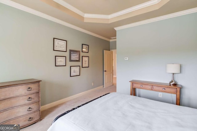 bedroom with light colored carpet, crown molding, and a tray ceiling