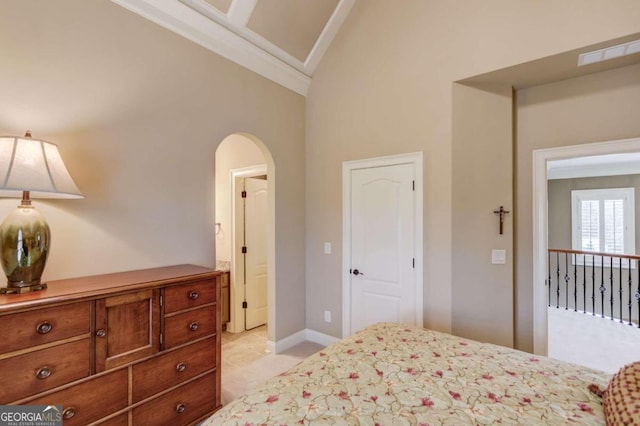 bedroom featuring light tile patterned floors and high vaulted ceiling