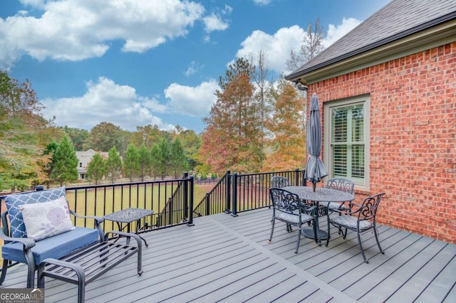 wooden deck featuring a lawn