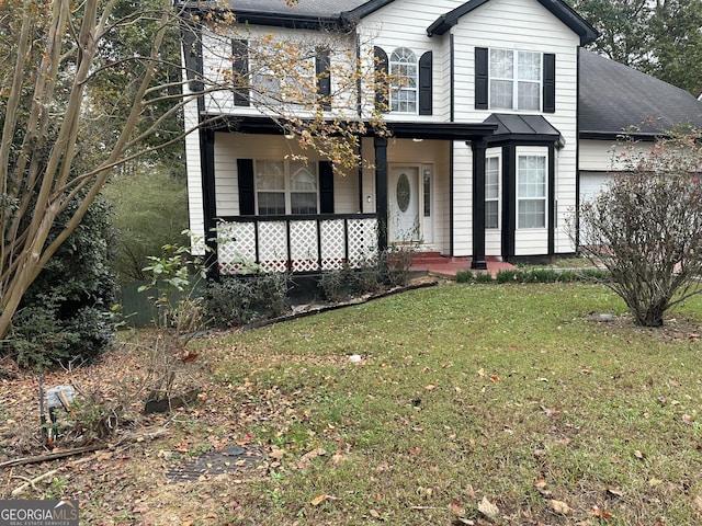 view of front property with covered porch and a front lawn